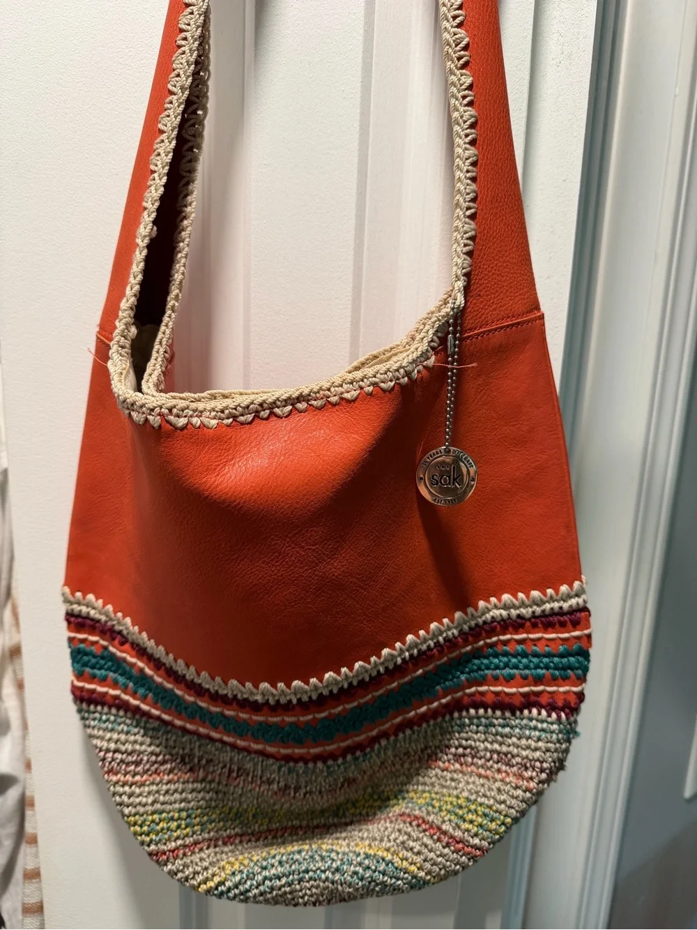 The Sak Orange Leather Hobo with Multicolor Crochet Trim